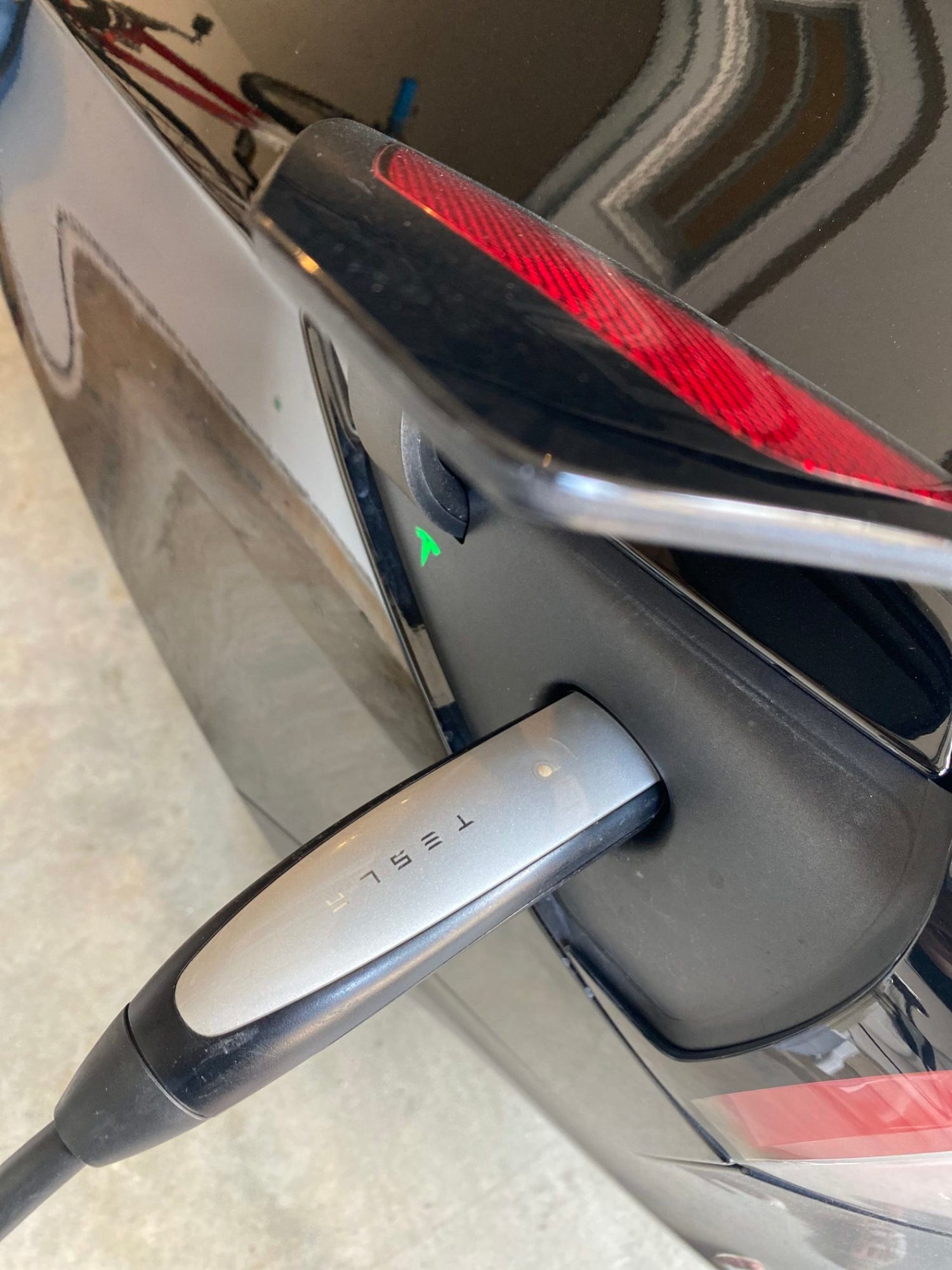 Electric vehicle Tesla charger plug. Garage Charge at home electric vehicle EV charging station installation. Free consultation for EV charger installation projects in Central Virginia, Richmond, Charlottesville, Harrisonburg, Lynchburg.